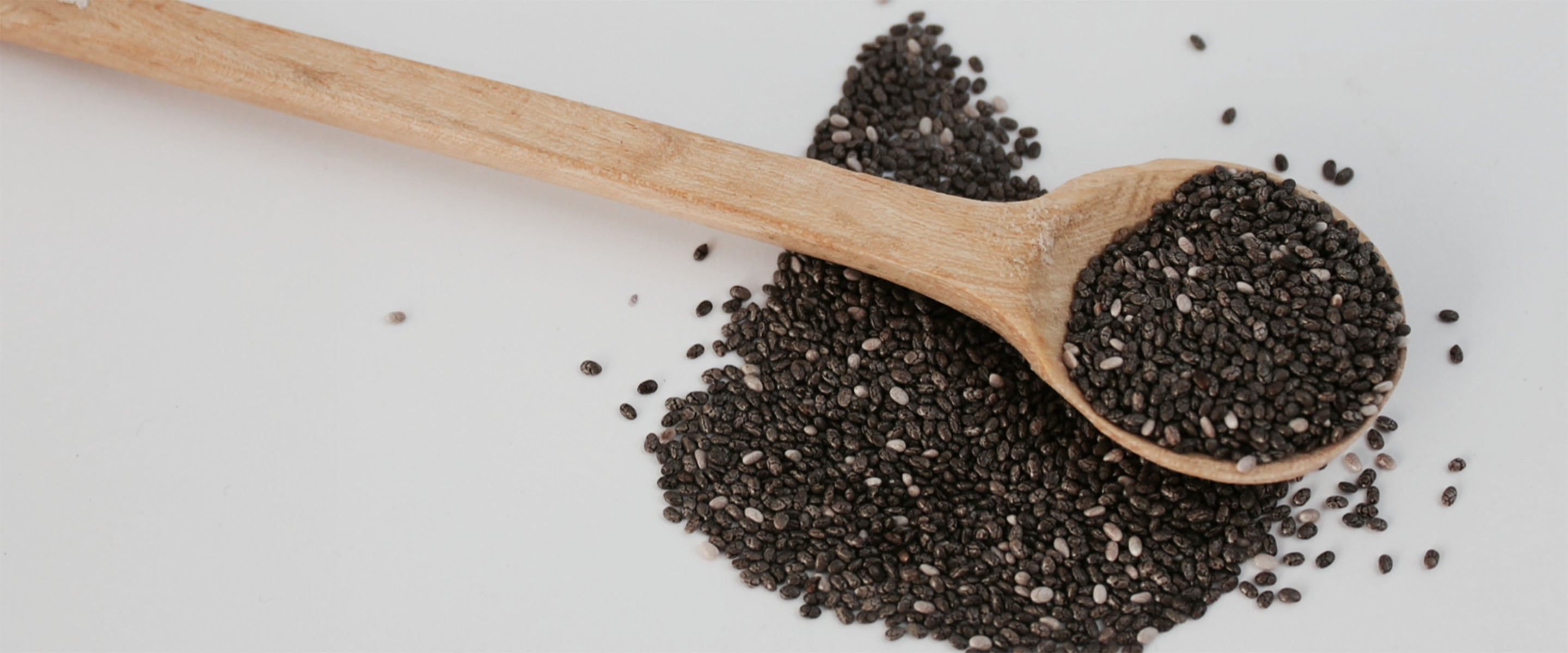 Ingredients like these seeds in the spoon on the table help to bring healthy radiant skin into reality for acne and body.