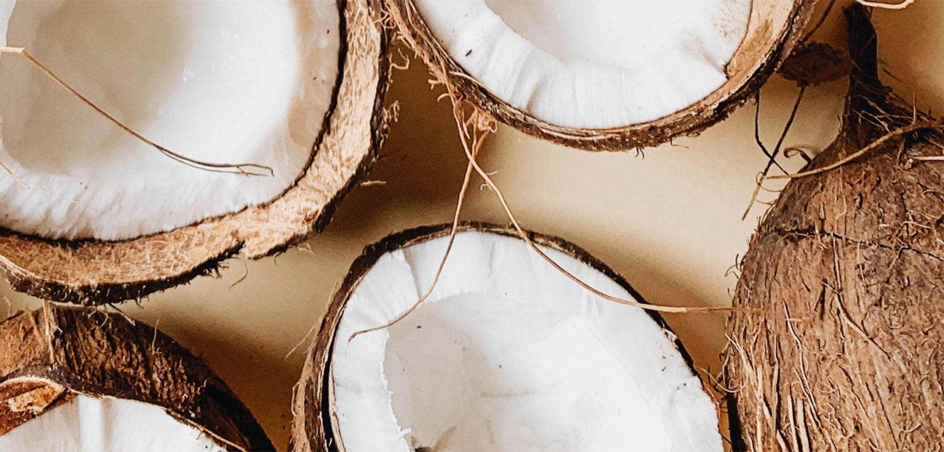 The oil from these coconuts laying on the table help to bring you great skin and beard from our face and body skincare for men.