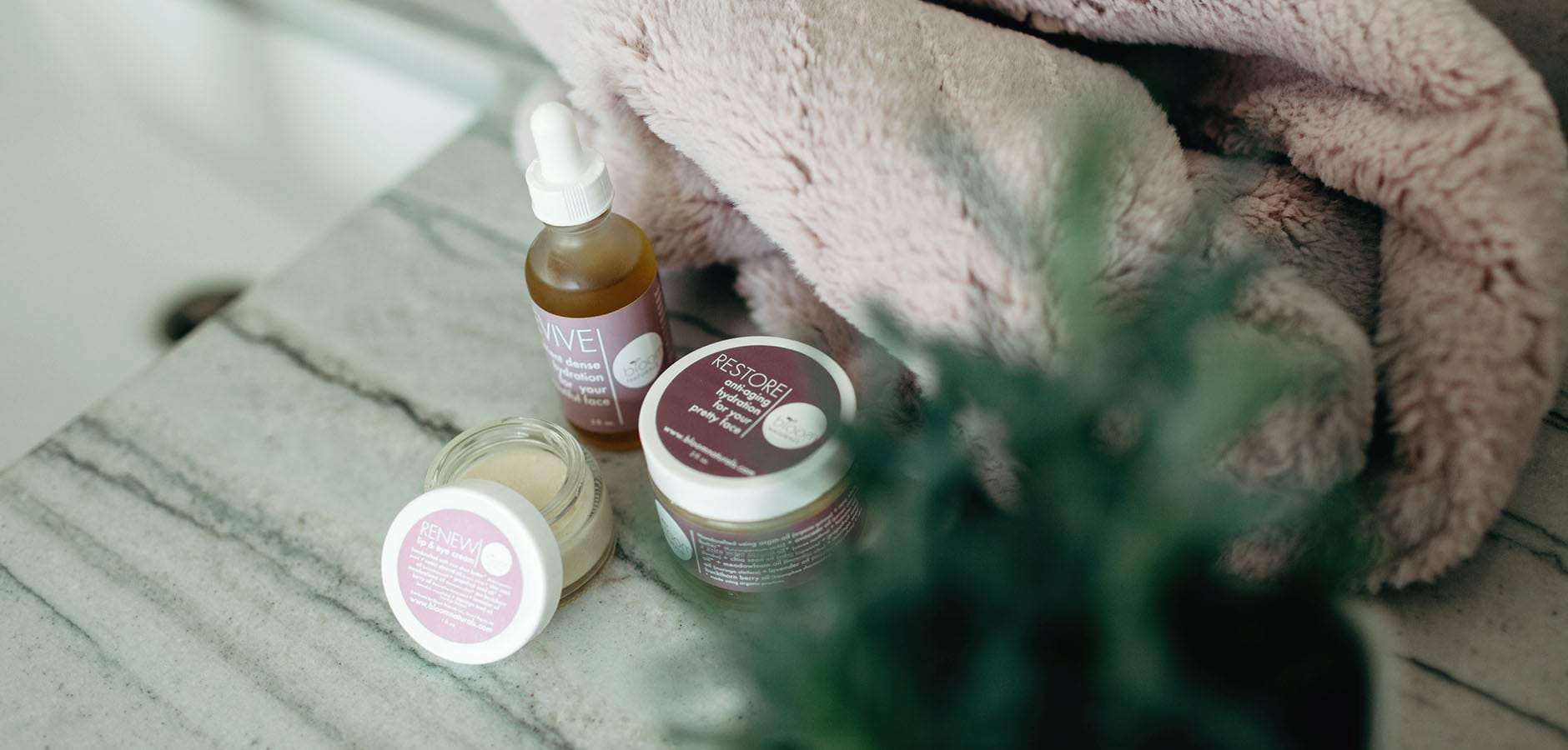 Relief, Revive, Restore, and Renew sitting next to the towel on the bathroom counter tighten the skin to reduce fine lines.